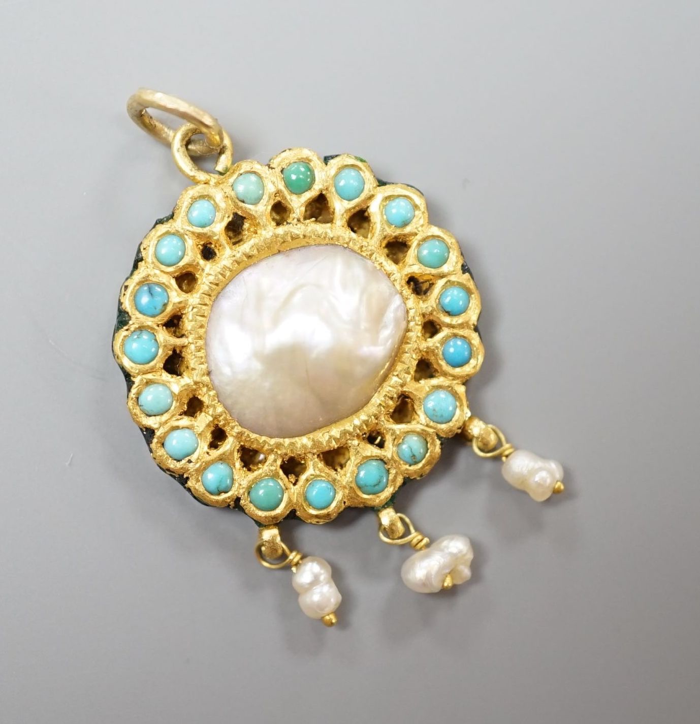 An Indian yellow metal, turquoise, baroque pearl and enamel set drop pendant, overall 33mm.